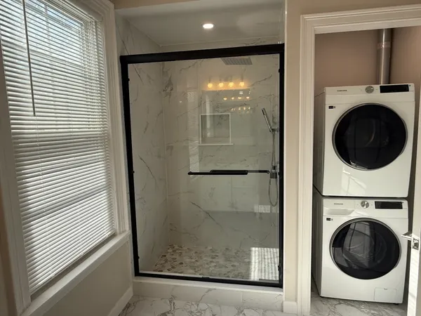 a view of a hallway with washer and dryer