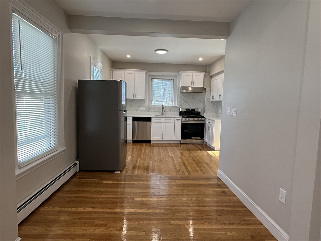 6 Channing Street, Unit 2 Newton, MA 02458 - Photo 2 of 17 a kitchen with a refrigerator and a stove top oven