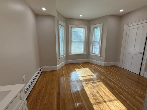 a view of wooden floor in a hall with wooden floor