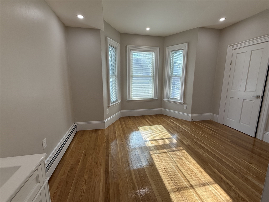 6 Channing Street, Unit 2 Newton, MA 02458 - Photo 8 of 17 a view of wooden floor in a hall with wooden floor
