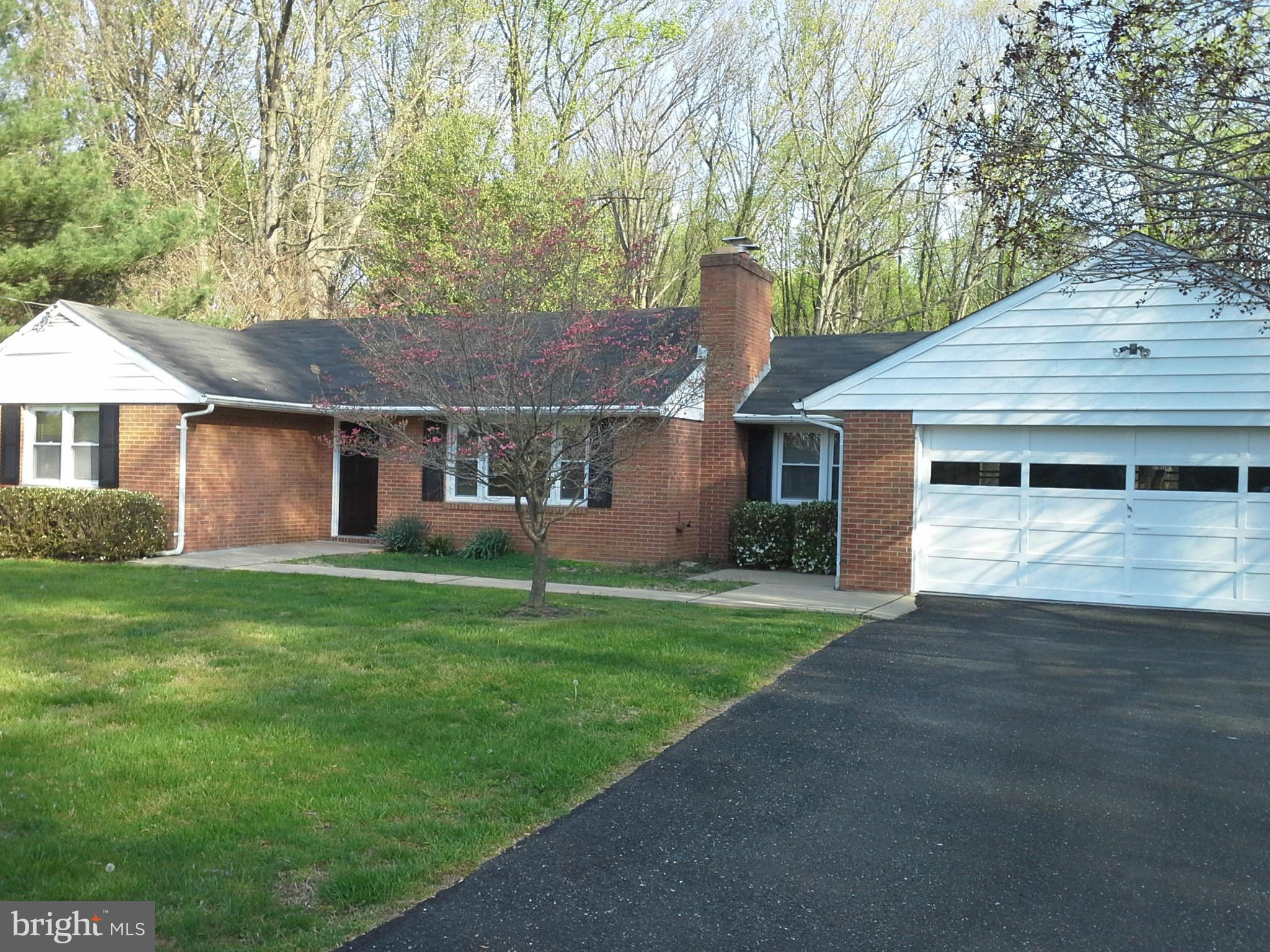9912 Fox Hill Road Perry Hall, MD 21128 - Photo 1 of 26 a front view of a house with a garden and yard