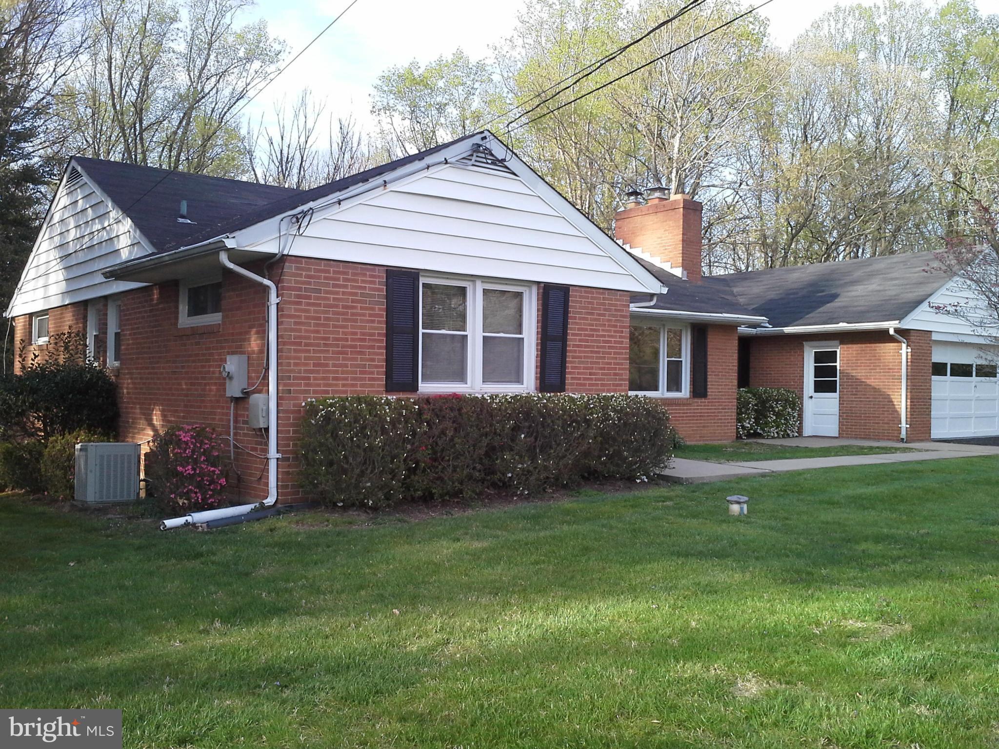 9912 Fox Hill Road Perry Hall, MD 21128 - Photo 2 of 26 a front view of a house with a garden
