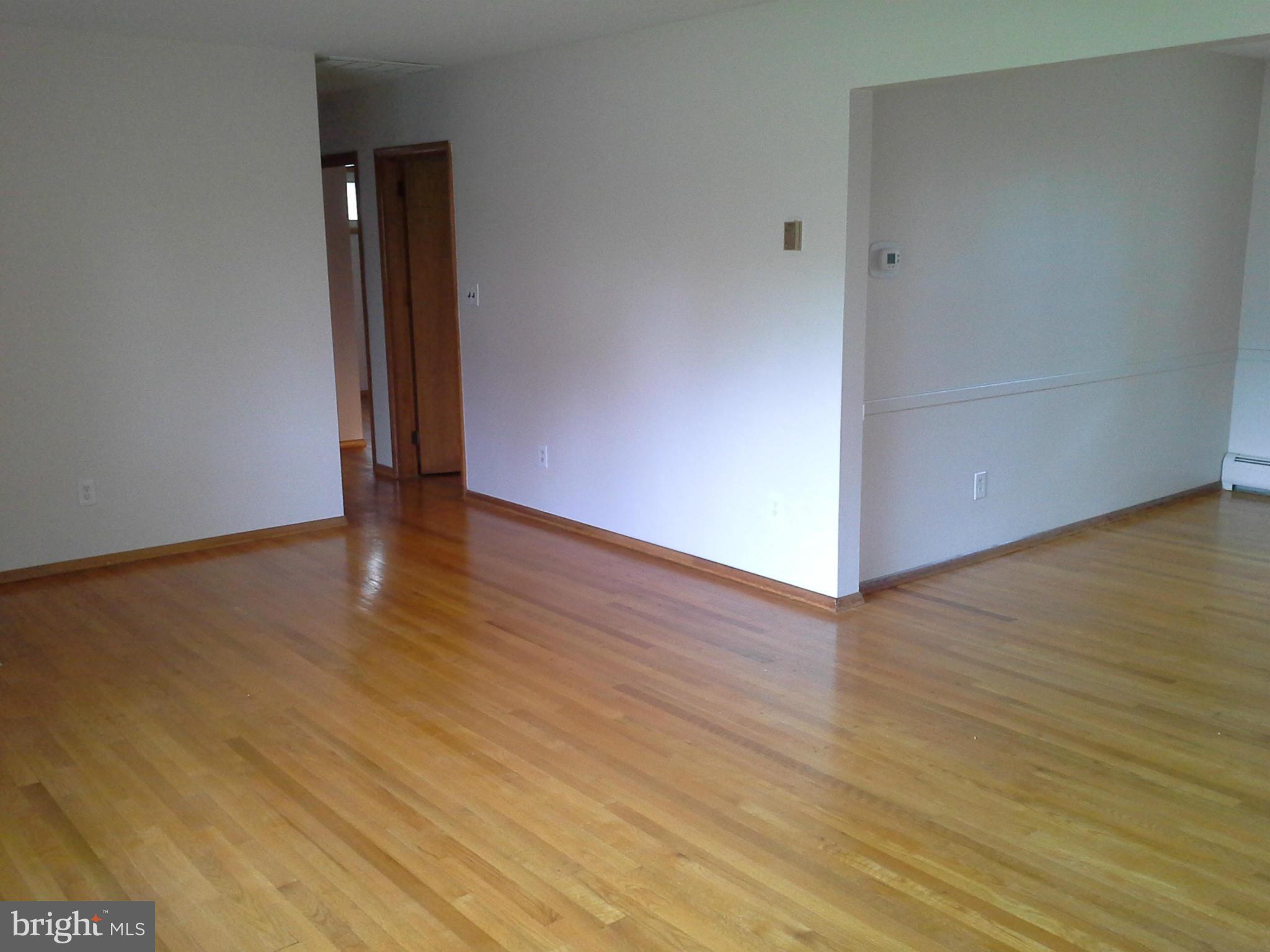 9912 Fox Hill Road Perry Hall, MD 21128 - Photo 11 of 26 a view of an empty room with wooden floor and a window