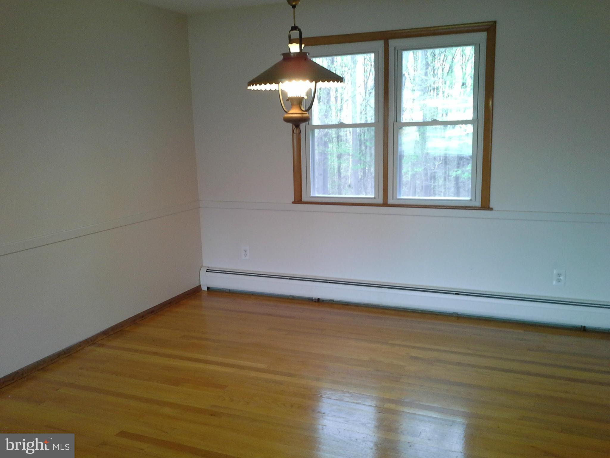 9912 Fox Hill Road Perry Hall, MD 21128 - Photo 12 of 26 wooden floor in an empty room with a window