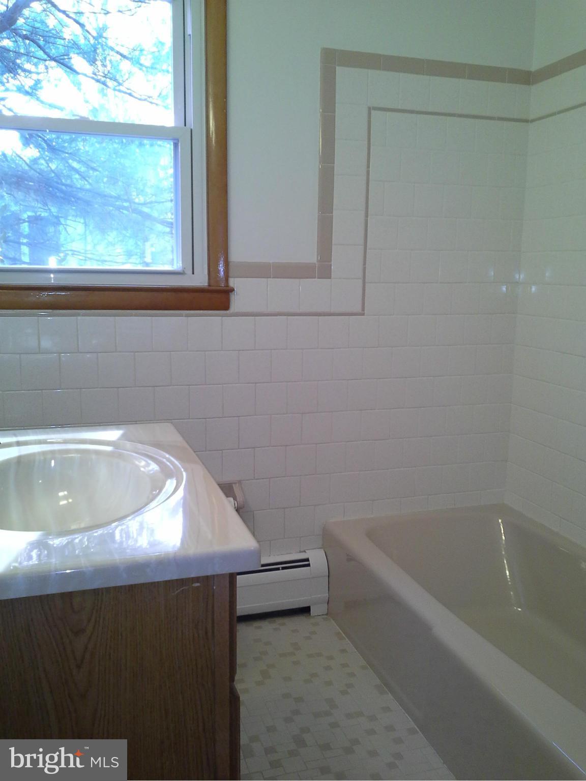 9912 Fox Hill Road Perry Hall, MD 21128 - Photo 15 of 26 a bathroom with a bathtub and window
