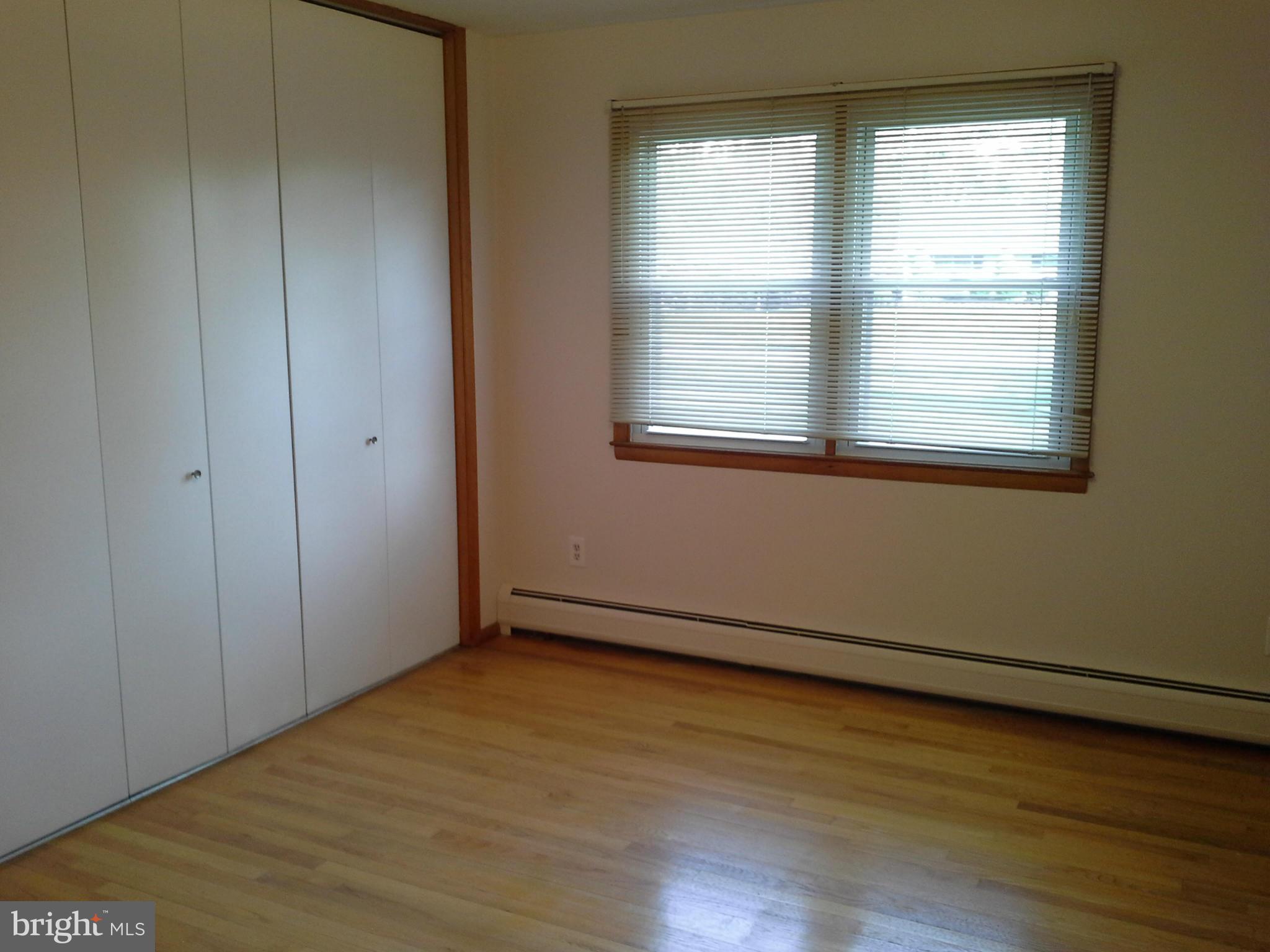 9912 Fox Hill Road Perry Hall, MD 21128 - Photo 16 of 26 an empty room with wooden floor and windows