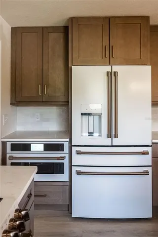 a bathroom with a toilet a sink a mirror a bathtub and vanity