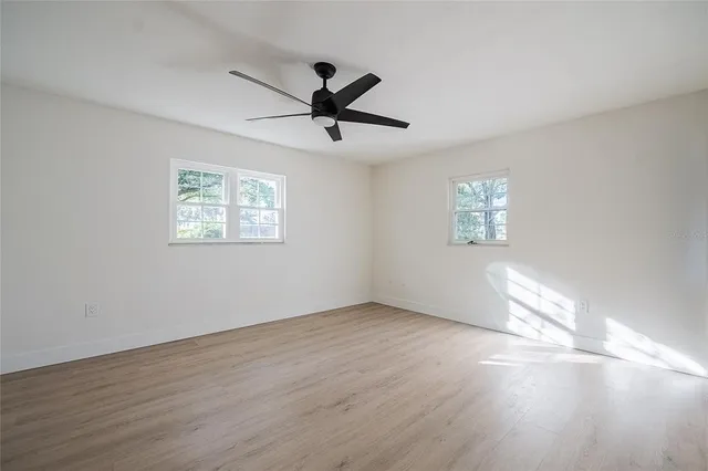 wooden floor in an empty room with a window