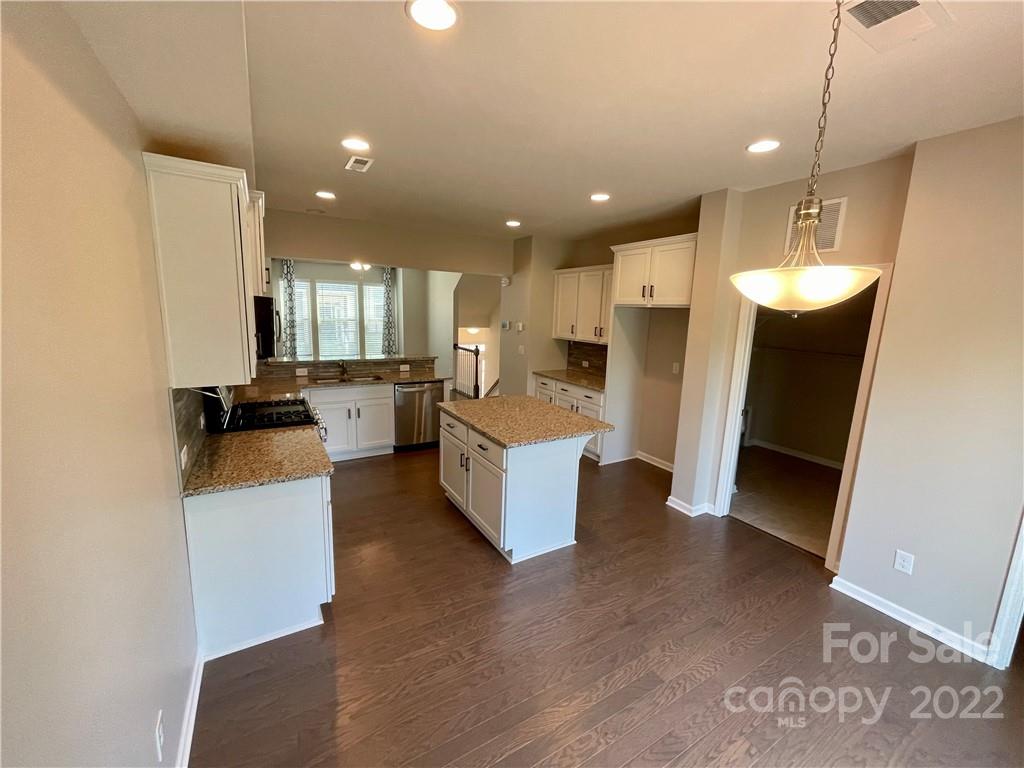 715 Swift Run Tega Cay, SC 29708 - Photo 7 of 24 a view of kitchen with refrigerator stove and wooden floor