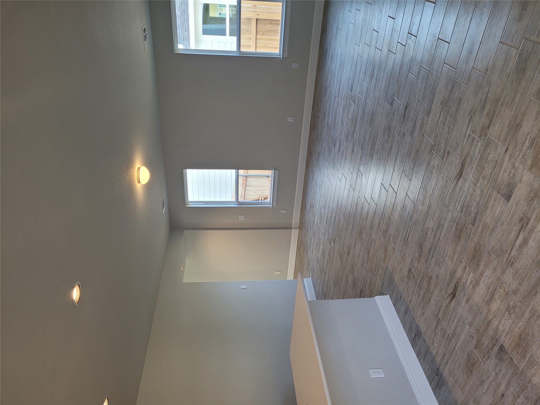 120 Free Stone Drive Georgetown, TX 78628 - Photo 9 of 40 The open-concept living area features elegant plank tile flooring and abundant natural light from multiple windows.