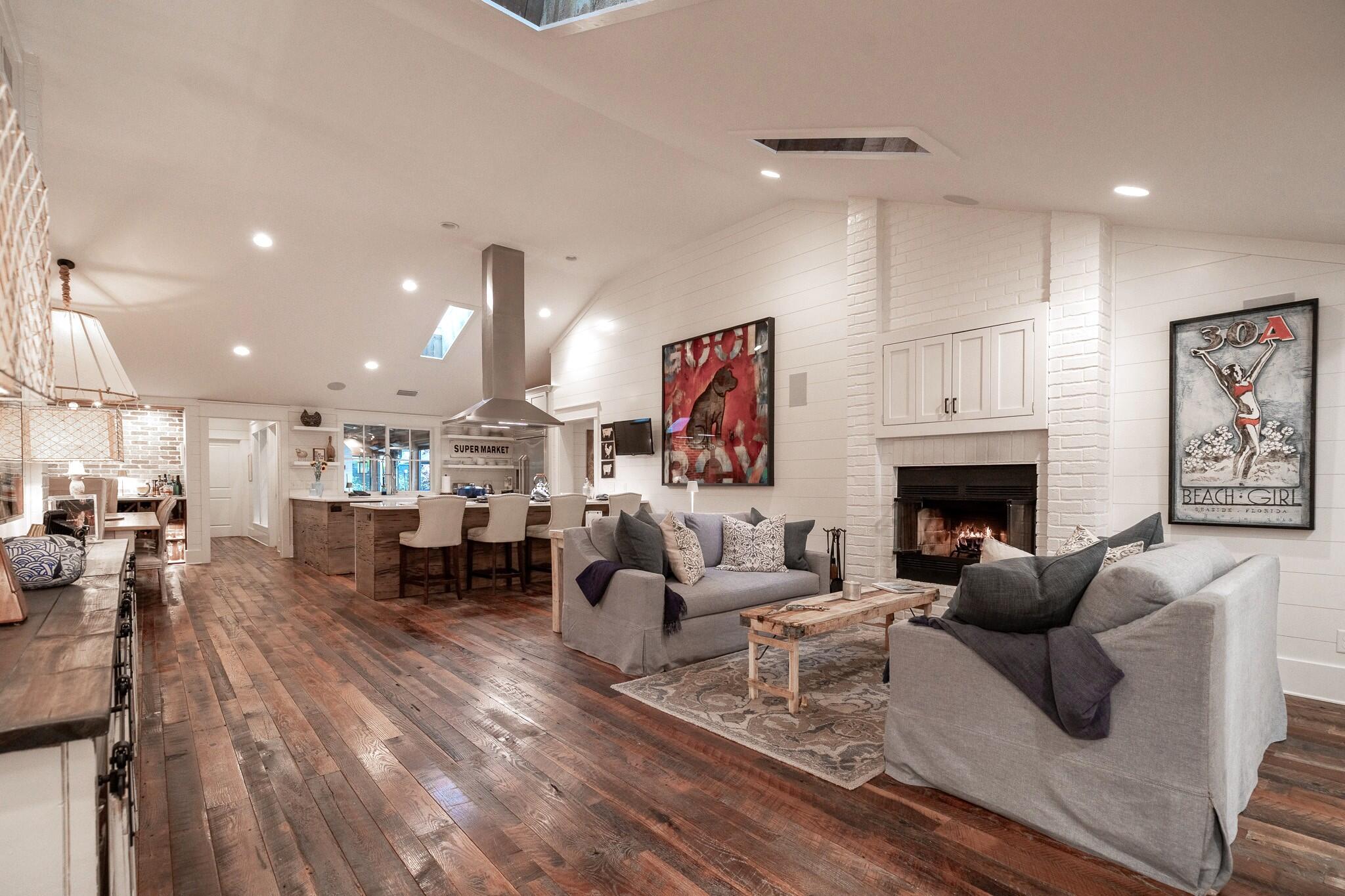 102 Camp Creek Road South Inlet Beach, FL 32461 - Photo 11 of 73 a living room with furniture a fireplace and a dining table with wooden floor