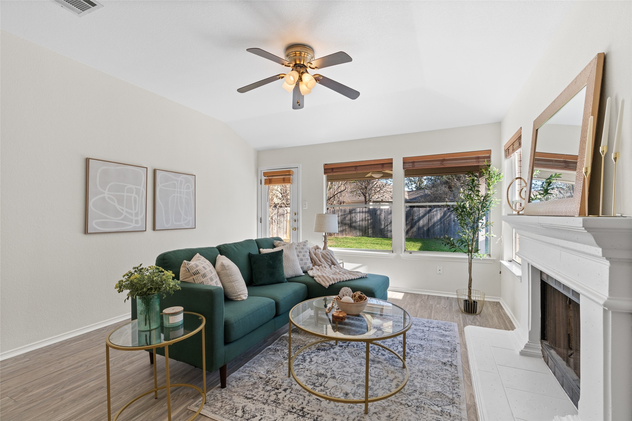 8430 Alvin High Lane Austin, TX 78729 - Photo 12 of 31 a living room with furniture a fireplace and a large window
