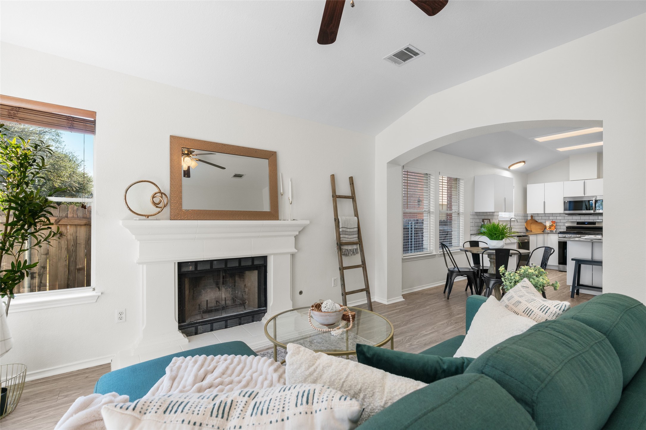 8430 Alvin High Lane Austin, TX 78729 - Photo 14 of 31 a living room with furniture a fireplace and a potted plant
