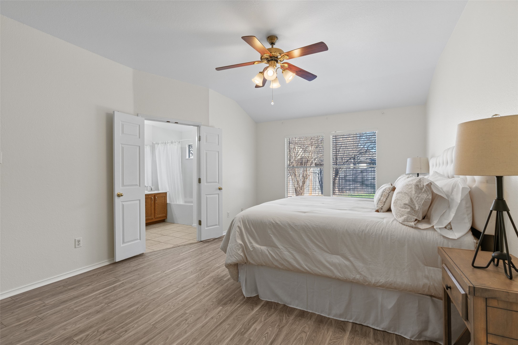 8430 Alvin High Lane Austin, TX 78729 - Photo 16 of 31 a bedroom with a large bed and a chandelier