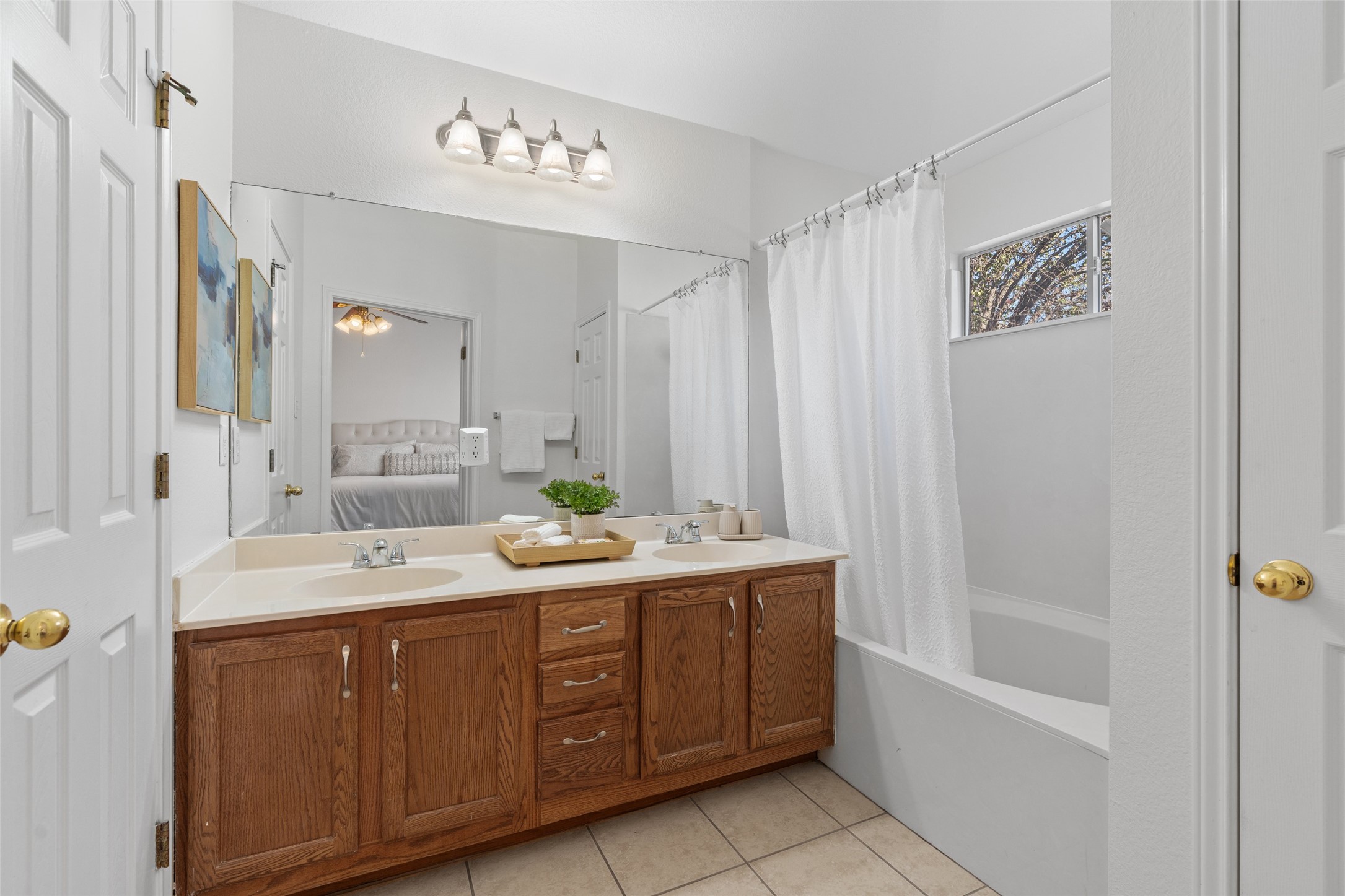 8430 Alvin High Lane Austin, TX 78729 - Photo 17 of 31 a spacious bathroom with a double vanity sink a large mirror and shower