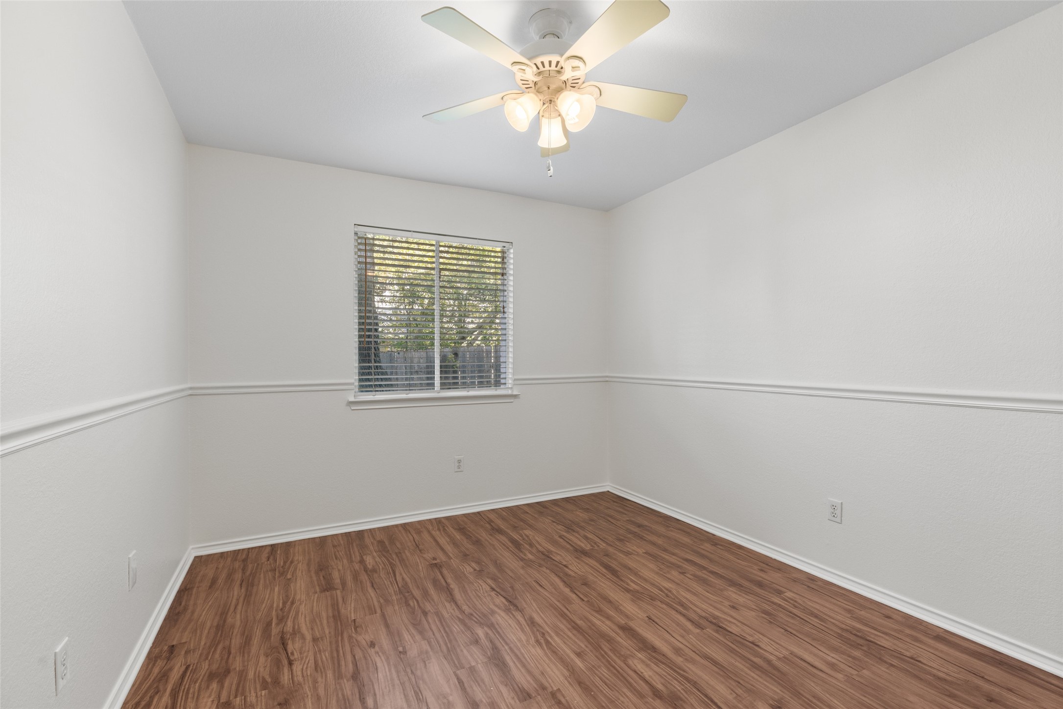 8430 Alvin High Lane Austin, TX 78729 - Photo 21 of 31 an empty room with a window and a fan