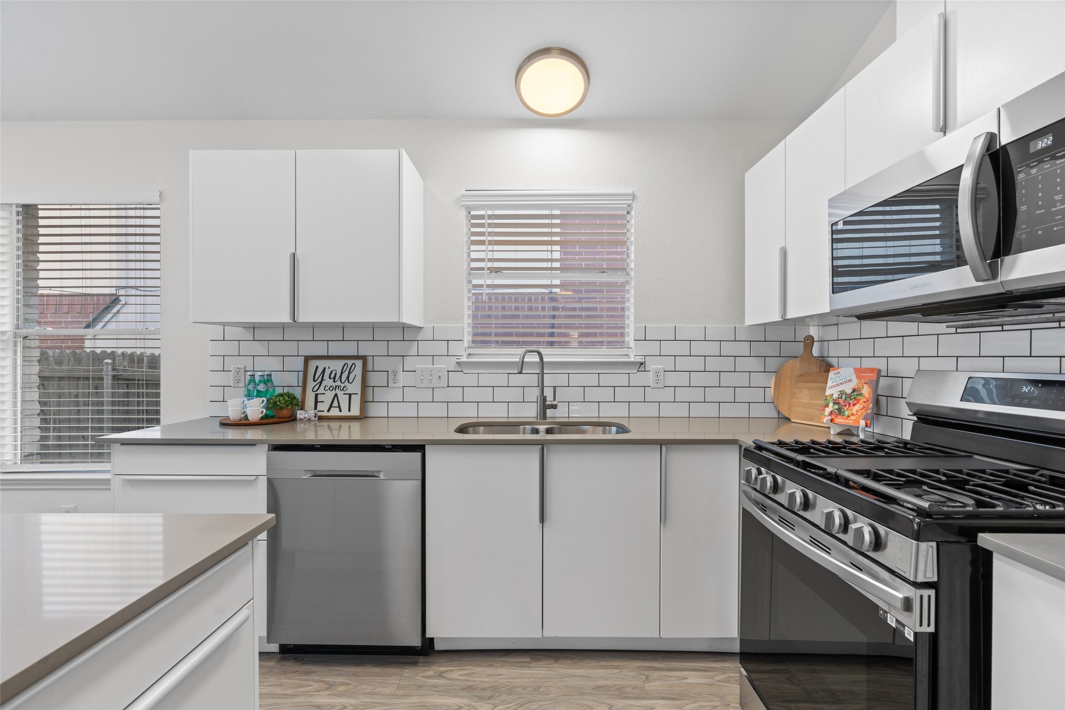 8430 Alvin High Lane Austin, TX 78729 - Photo 8 of 31 a kitchen with stainless steel appliances a sink stove and cabinets