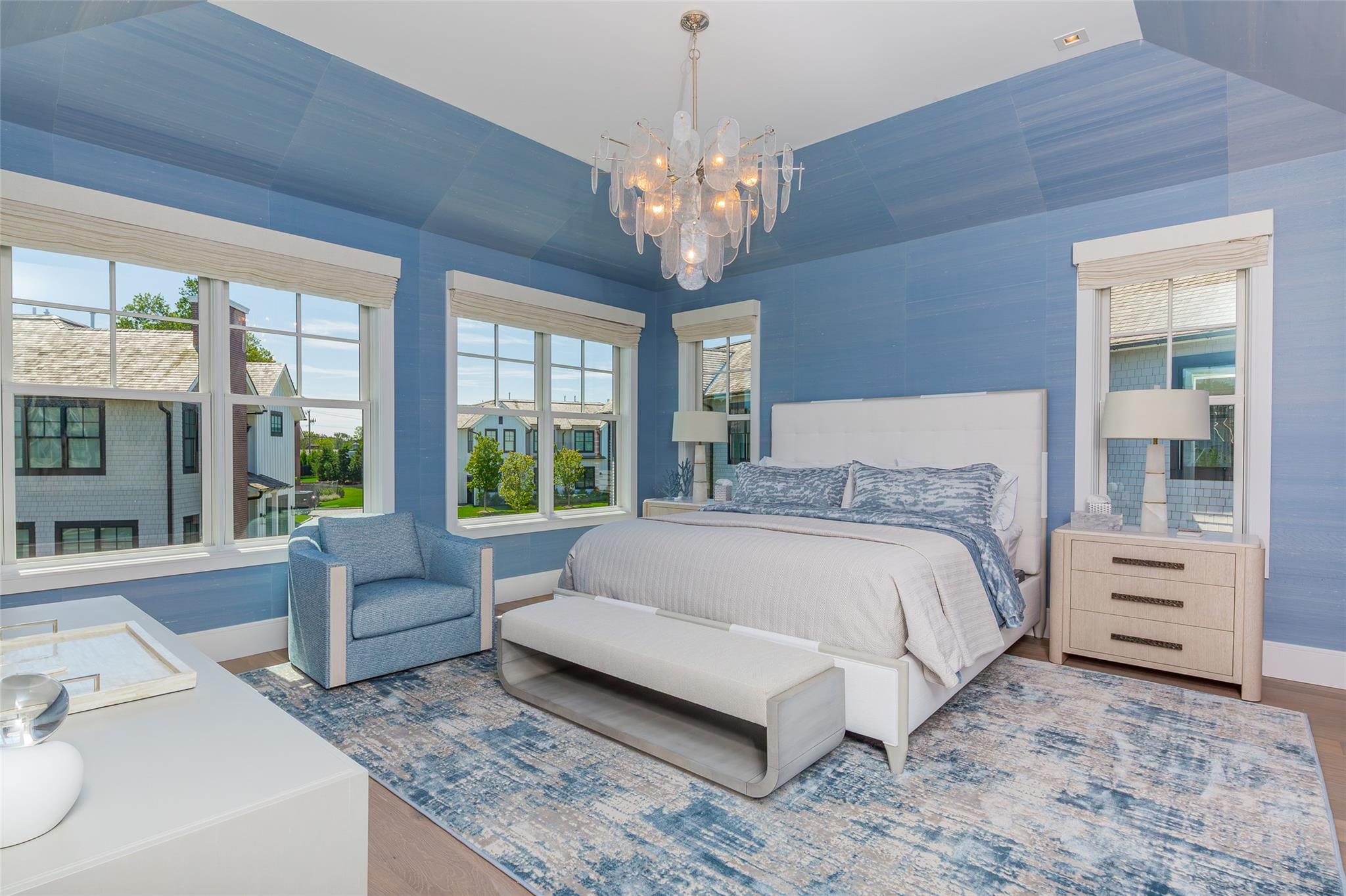 1 Spruce Court Water Mill, NY 11976 - Photo 15 of 35 Bedroom with a chandelier, multiple windows, and wood finished floors
