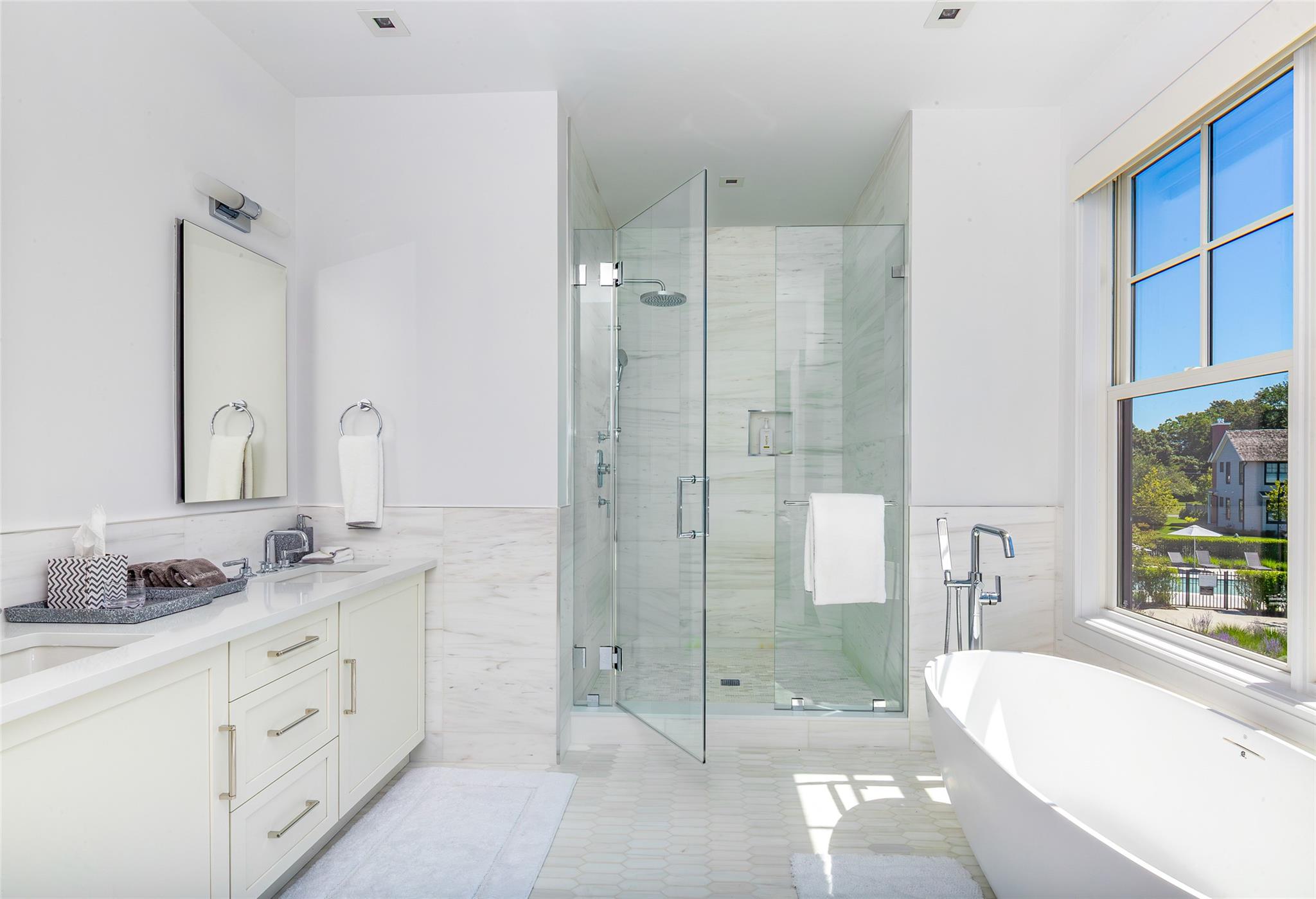 1 Spruce Court Water Mill, NY 11976 - Photo 19 of 35 Full bathroom featuring tile walls, a wainscoted wall, a freestanding bath, a stall shower, and double vanity
