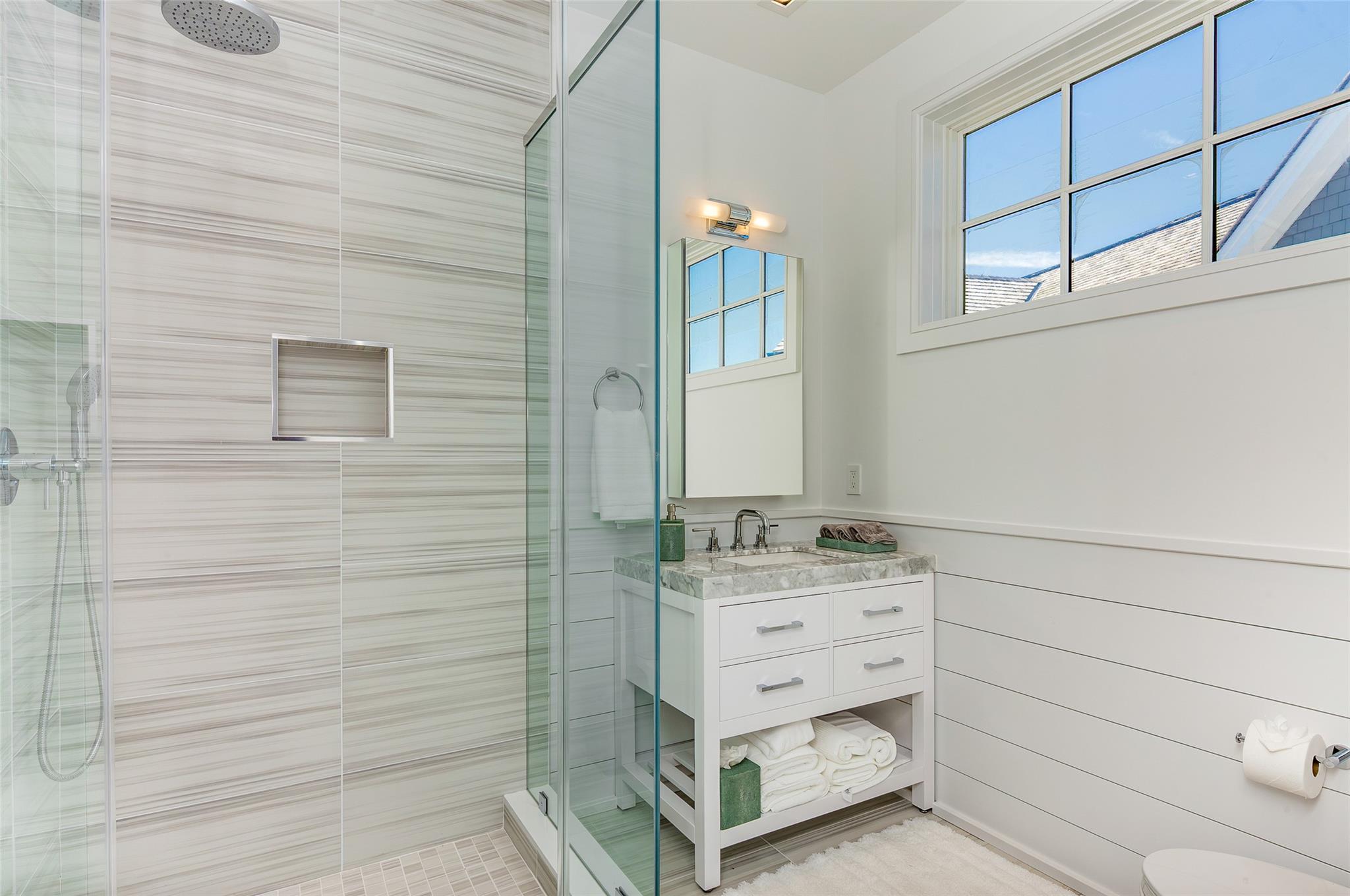 1 Spruce Court Water Mill, NY 11976 - Photo 25 of 35 Bathroom featuring a shower stall, vanity, and wainscoting