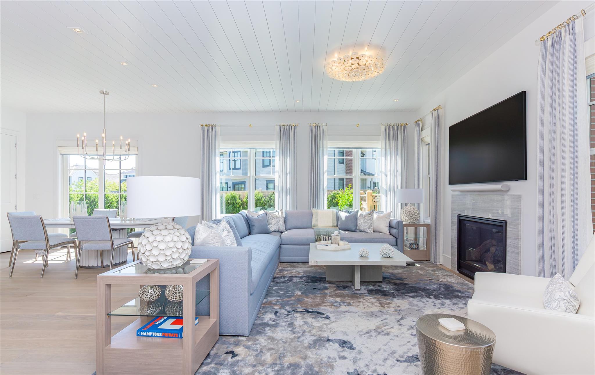 1 Spruce Court Water Mill, NY 11976 - Photo 5 of 35 Living room with a chandelier, a glass covered fireplace, wood finished floors, and wood ceiling