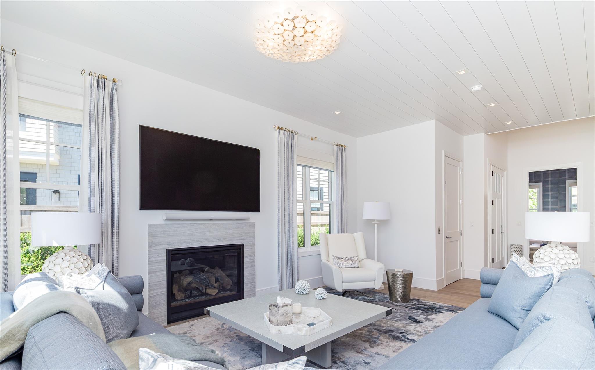 1 Spruce Court Water Mill, NY 11976 - Photo 6 of 35 Living room featuring healthy amount of natural light, wood finished floors, a high end fireplace, and recessed lighting