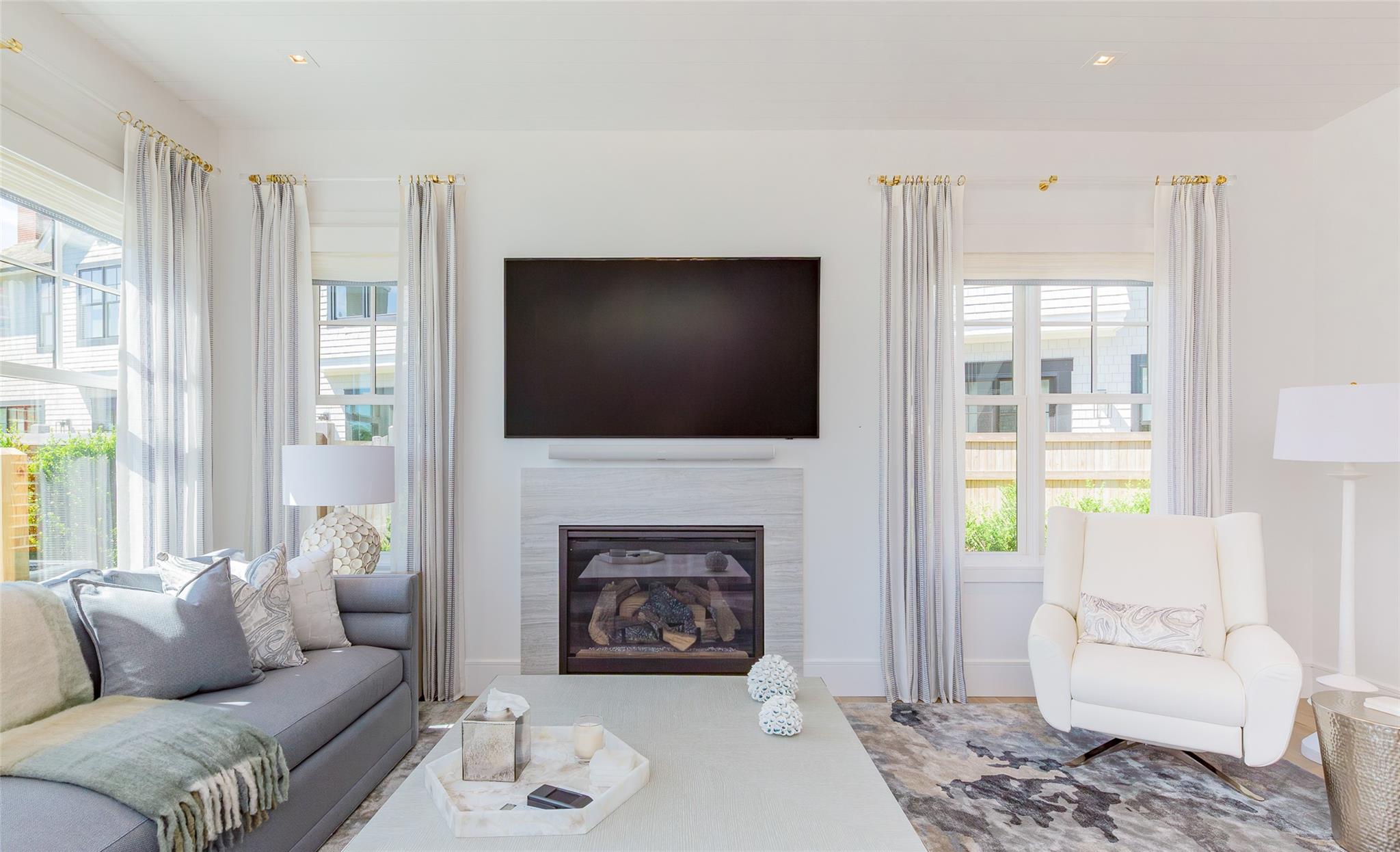 1 Spruce Court Water Mill, NY 11976 - Photo 7 of 35 Living room with plenty of natural light and a fireplace with flush hearth