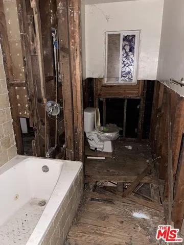 a view of balcony with furniture and a potted plant