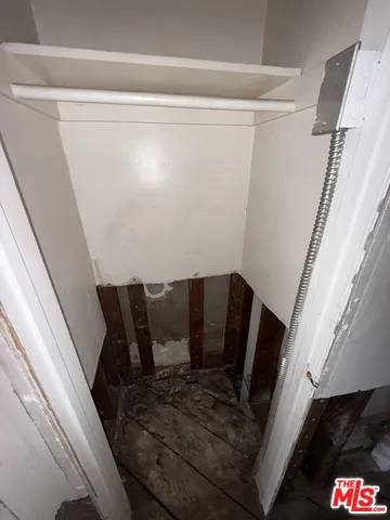 a view of a room with wooden floor and a sink
