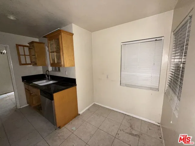 an empty room with window and hallway