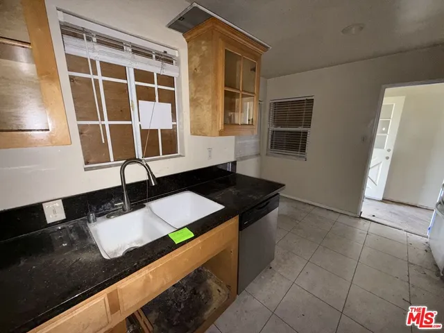 a kitchen with a sink and a stove top oven