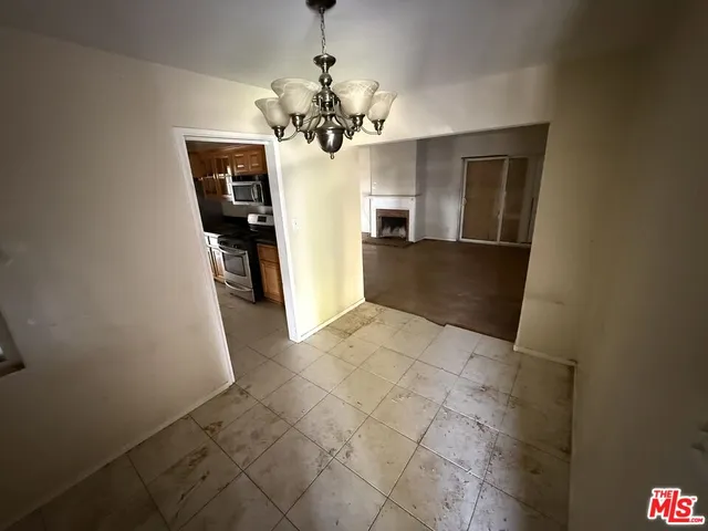 a view of a hallway with a chandelier