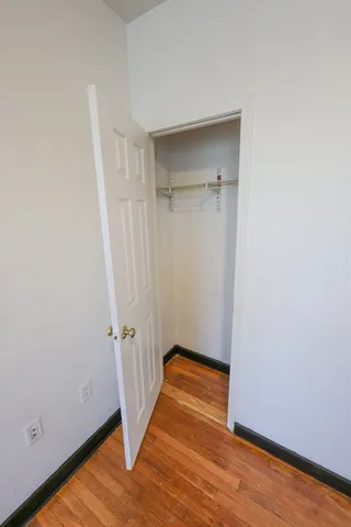 a view of a room with wooden floor and white walls