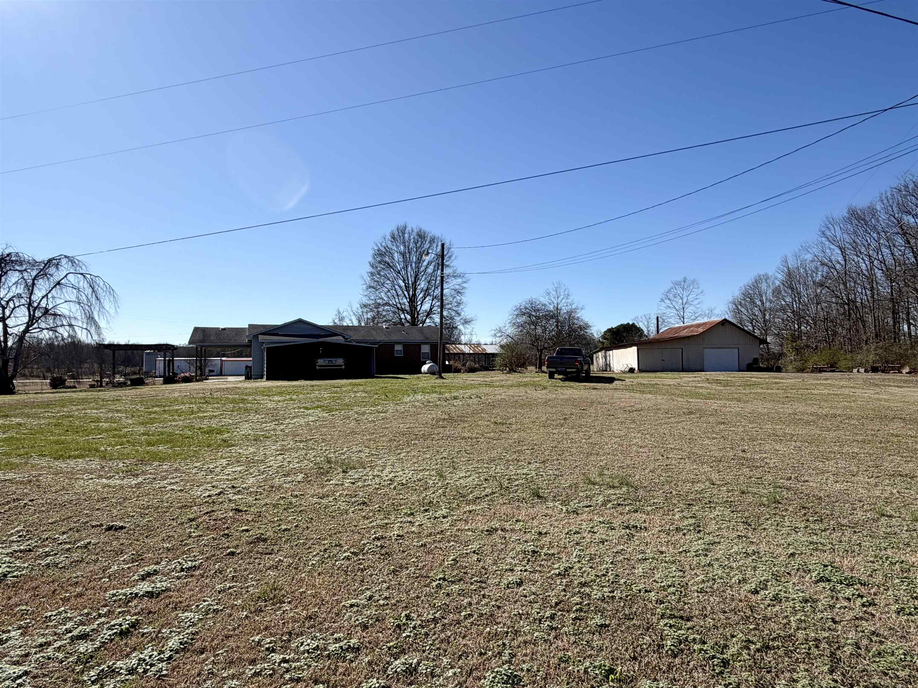 254 Michie Road Michie, TN 38357 - Photo 16 of 16 View of grassy yard with a garage