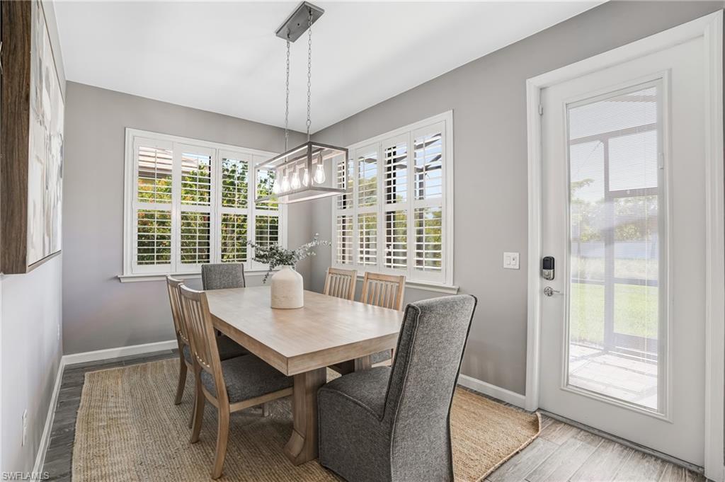 20308 Corkscrew Shores Boulevard Estero, FL 33928 - Photo 13 of 47 Dining room with wood finished floors, baseboards, and healthy amount of natural light