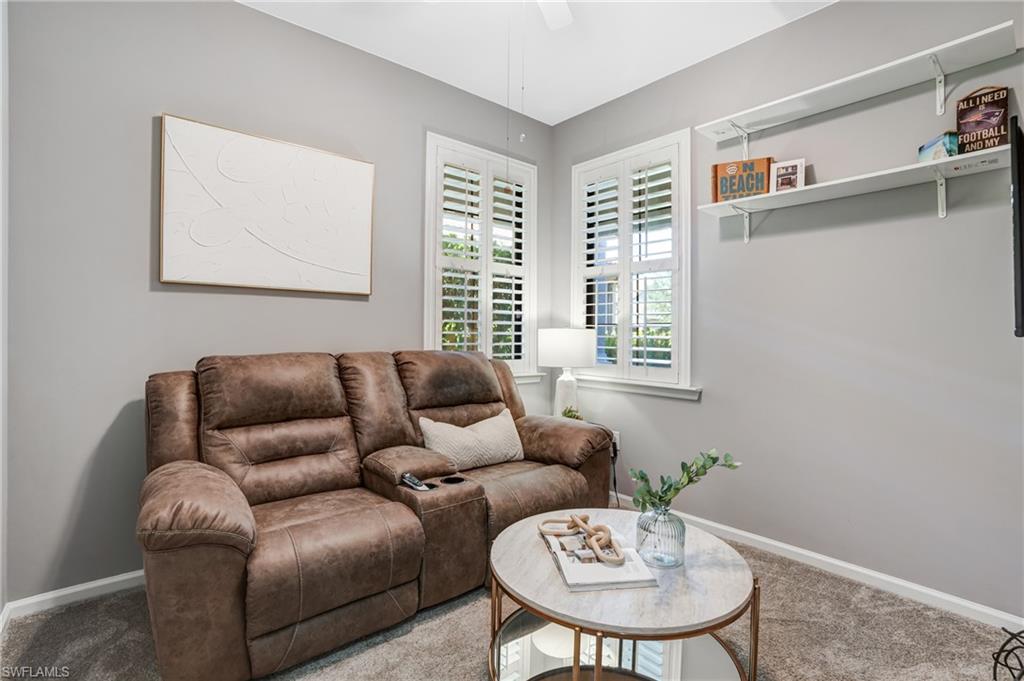 20308 Corkscrew Shores Boulevard Estero, FL 33928 - Photo 14 of 47 Carpeted living room featuring ceiling fan and baseboards