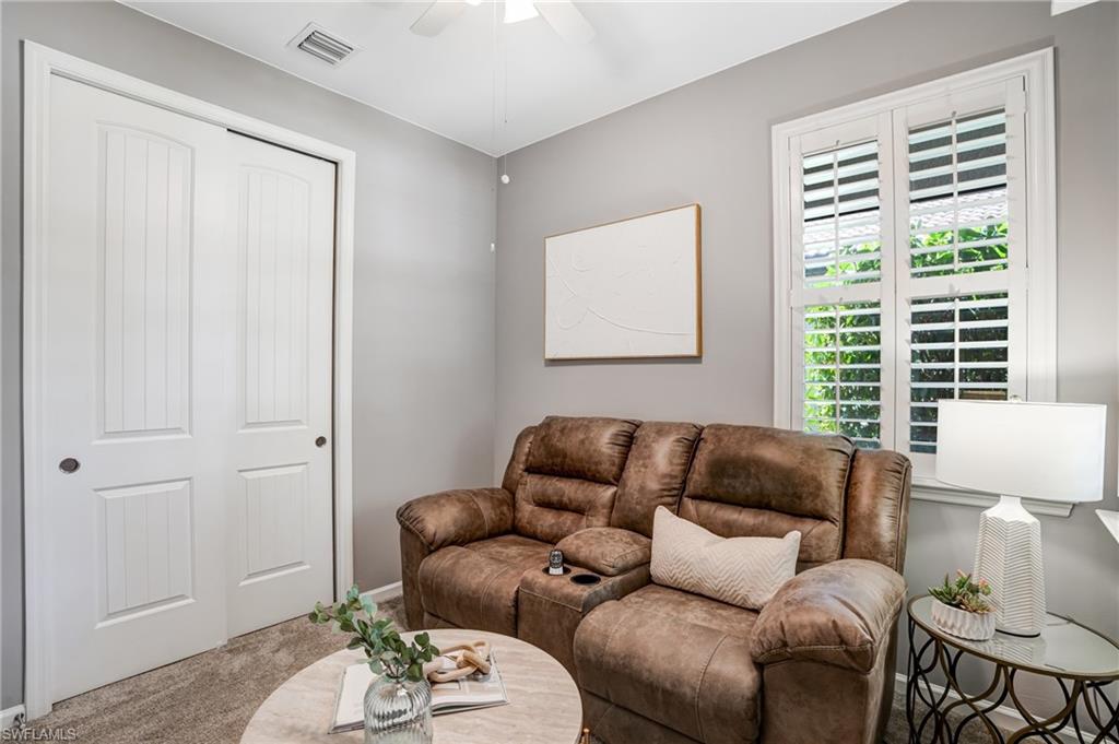 20308 Corkscrew Shores Boulevard Estero, FL 33928 - Photo 15 of 47 Carpeted living room with a ceiling fan and baseboards