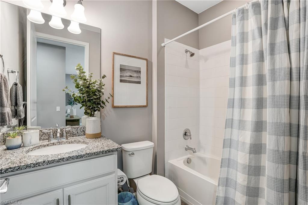 20308 Corkscrew Shores Boulevard Estero, FL 33928 - Photo 23 of 47 Bathroom with vanity, toilet, and shower / bath combo with shower curtain