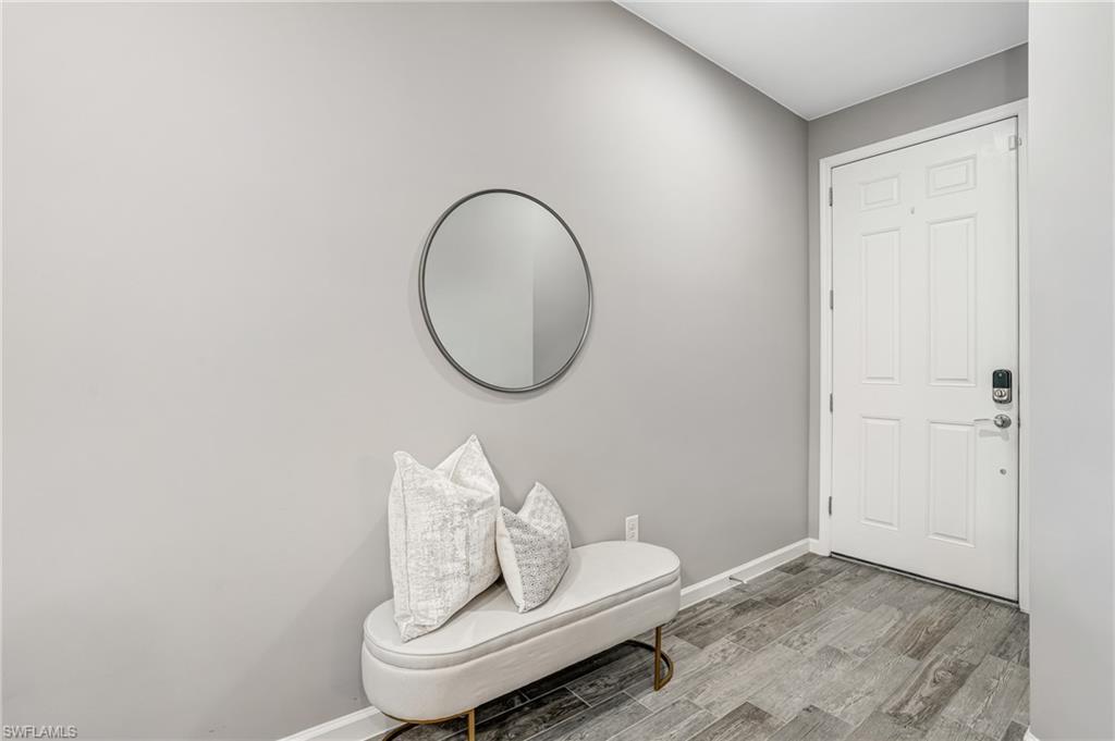 20308 Corkscrew Shores Boulevard Estero, FL 33928 - Photo 3 of 47 Entryway featuring light wood-style flooring and baseboards