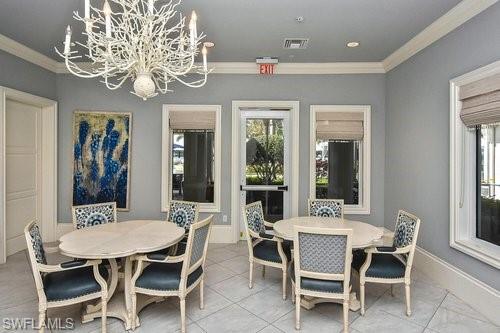 20308 Corkscrew Shores Boulevard Estero, FL 33928 - Photo 43 of 47 Dining area with crown molding, a chandelier, tile patterned floors, and baseboards