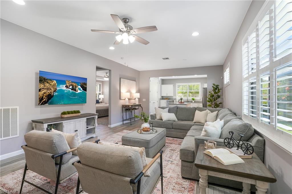 20308 Corkscrew Shores Boulevard Estero, FL 33928 - Photo 5 of 47 Living room with light wood-type flooring, a ceiling fan, baseboards, and recessed lighting