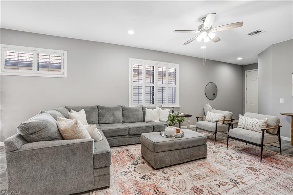 20308 Corkscrew Shores Boulevard Estero, FL 33928 - Photo 7 of 47 Living room featuring a ceiling fan, plenty of natural light, recessed lighting, baseboards, and light wood-style floors