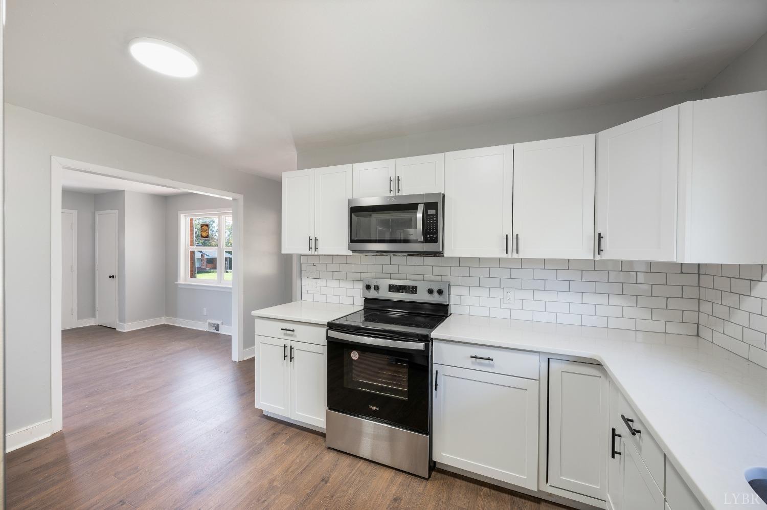 109 Hillside Road Hurt, VA 24563 - Photo 12 of 42 a kitchen with granite countertop white cabinets and stainless steel appliances