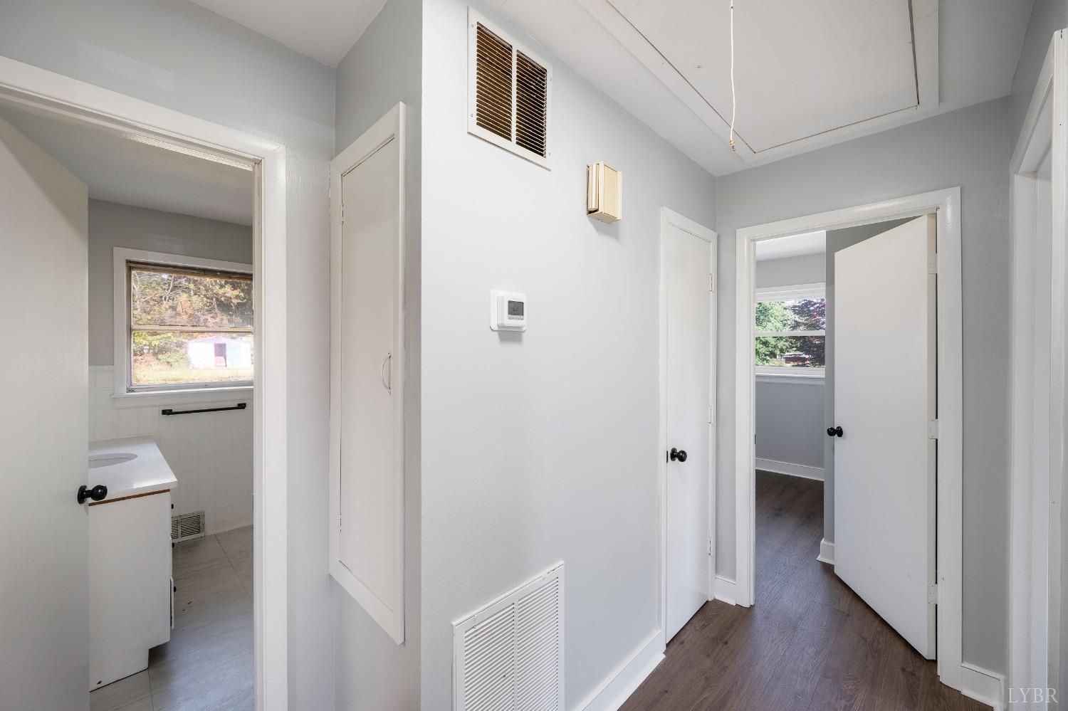 109 Hillside Road Hurt, VA 24563 - Photo 13 of 42 a view of a hallway with bathroom and wooden floor