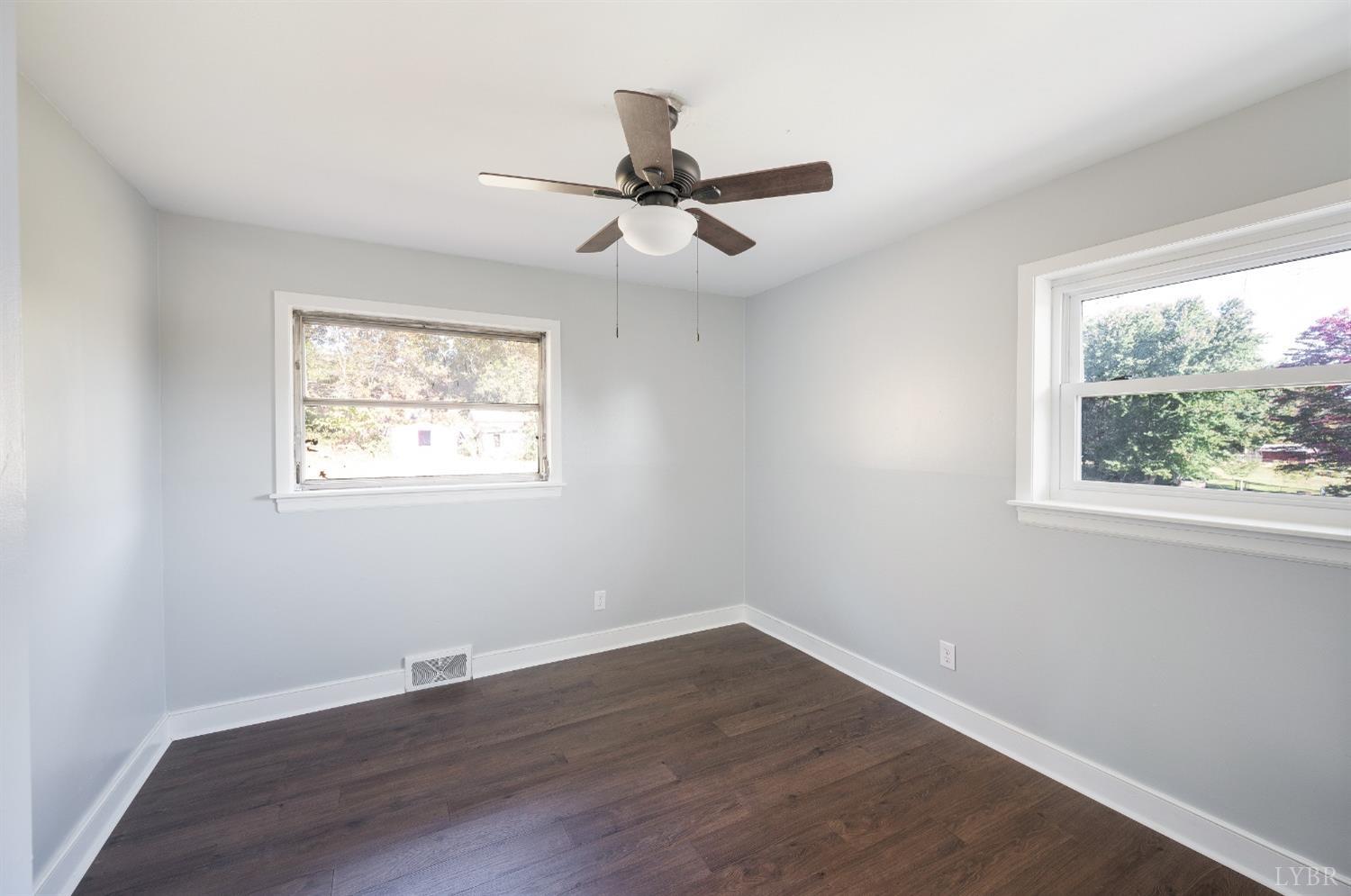 109 Hillside Road Hurt, VA 24563 - Photo 16 of 42 a view of an empty room with wooden floor and a window