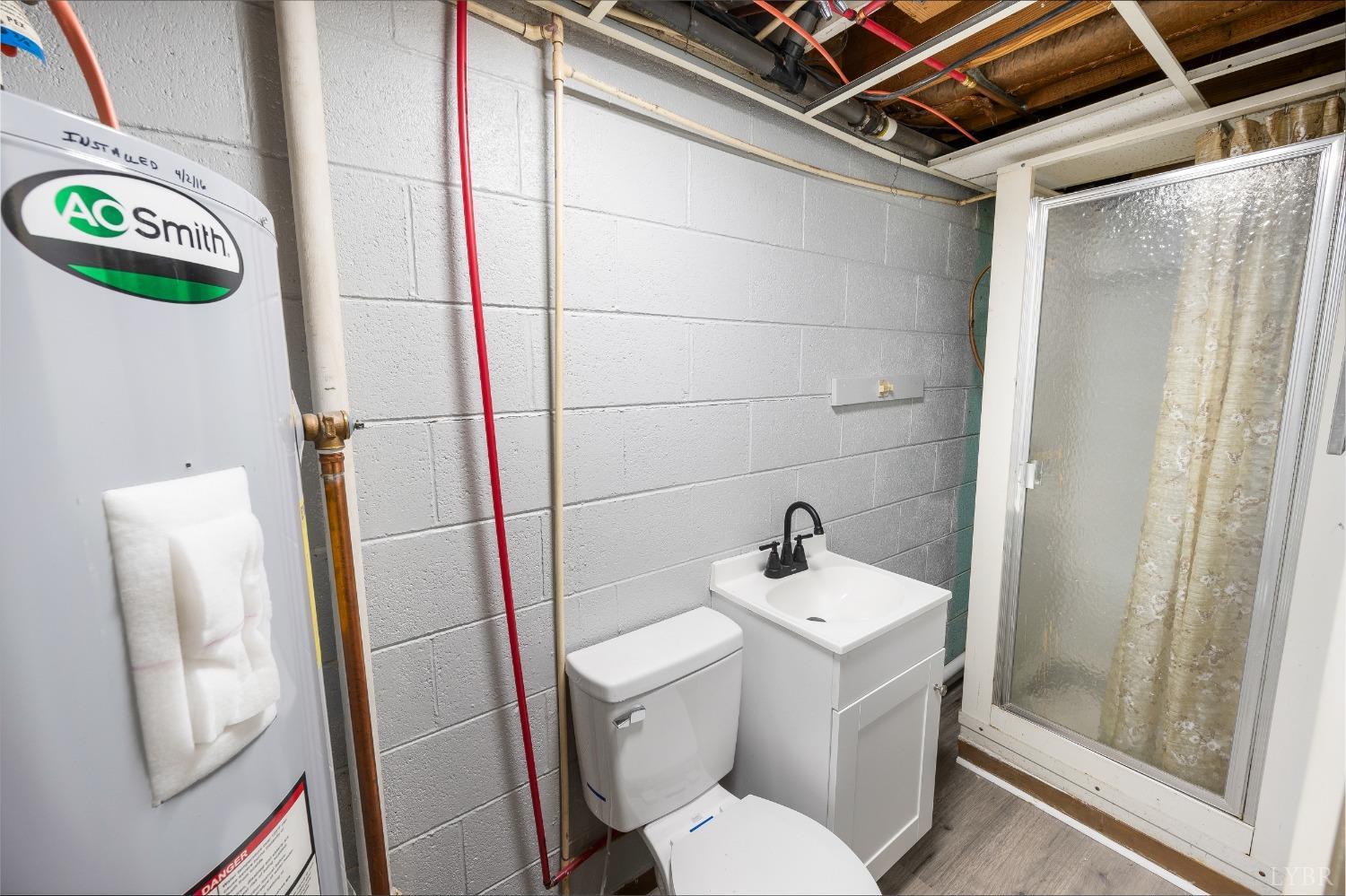 109 Hillside Road Hurt, VA 24563 - Photo 22 of 42 a white toilet sitting next to a bathroom sink