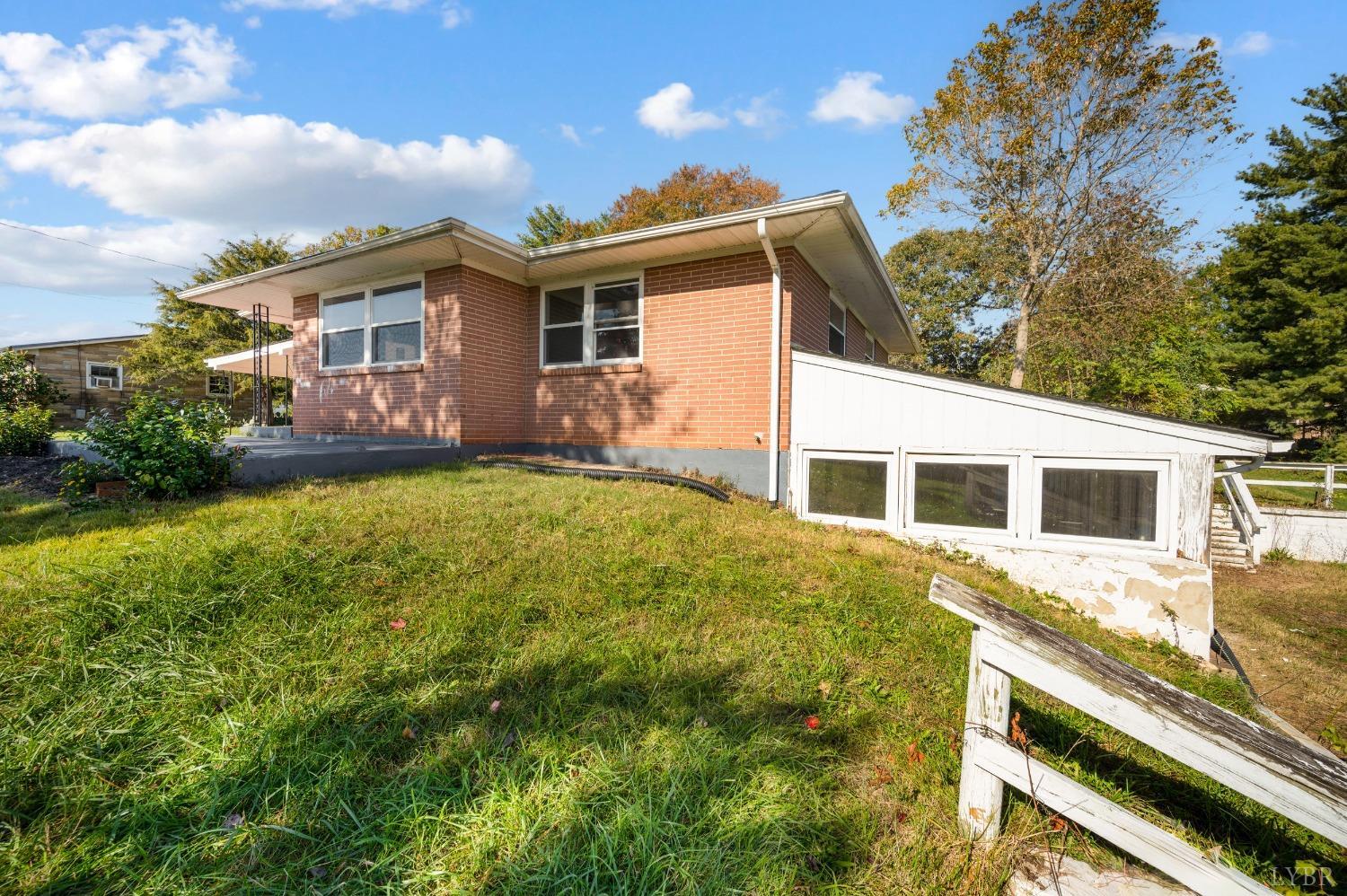 109 Hillside Road Hurt, VA 24563 - Photo 35 of 42 a front view of house with yard and trees in the background