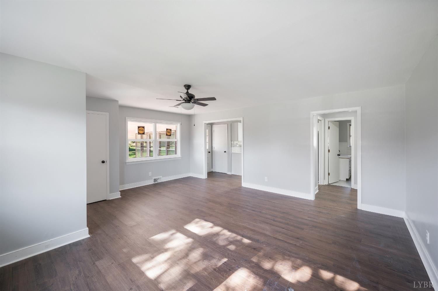 109 Hillside Road Hurt, VA 24563 - Photo 6 of 42 a view of an empty room with wooden floor and a window