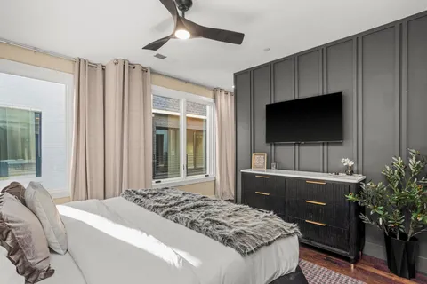 a bedroom with a bed and a flat screen tv