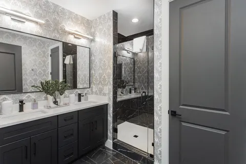 a bathroom with a shower sink and mirror